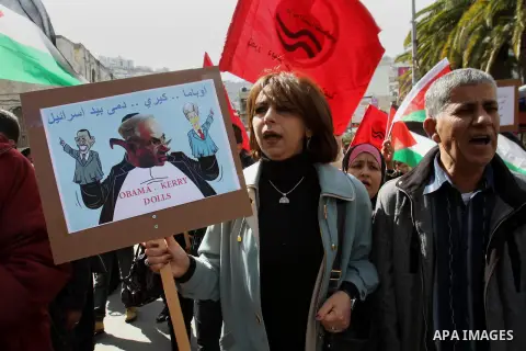 Members of Palestinian People's Party chant during a protest to demand the boycott of Israeli goods in the West bank city of Nablus, on Feb. 15 , 2014. Photo by Nedal Eshtayah