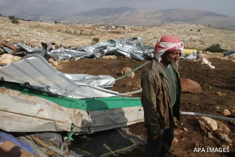 A Palestinian Bedouin man inspects the remains of his tent after it was demolished near the Palestinian West Bank town of Tubas in the Jordan valley, on Feb. 17, 2014. Palestinians said the Israeli military demolished ti...