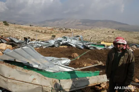A Palestinian Bedouin man inspects the remains of his tent after it was demolished near the Palestinian West Bank town of Tubas in the Jordan valley, on Feb. 17, 2014. Palestinians said the Israeli military demolished ti...