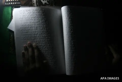 Palestinian Mahmoud Juhaish, 23, a blind youth studies at his house in Rafah refugee camp in southern Gaza strip on Feb. 17, 2014. Juhaish studies at the Islamic University in Gaza City as he suffers blindness, after his...