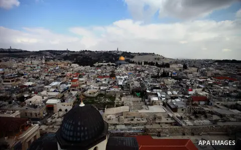 A general view from the tower of the Church of Redeemer shows the Dome of the Rock mosque, Islam's third holiest site, and the cross of the Church of the Holy Sepulchre in the old city of Jerusalem, on February 17, 2014...