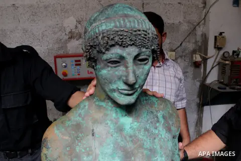 A picture taken on September 19, 2013 shows a 2,500-year-old bronze statue of the Greek god Apollo discovered by Palestinian fishermen last August. Lost for centuries, the rare bronze statue of the Greek God Apollo has m...