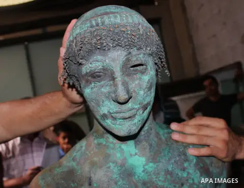 A picture taken on September 19, 2013 shows a 2,500-year-old bronze statue of the Greek god Apollo discovered by Palestinian fishermen last August. Lost for centuries, the rare bronze statue of the Greek God Apollo has m...