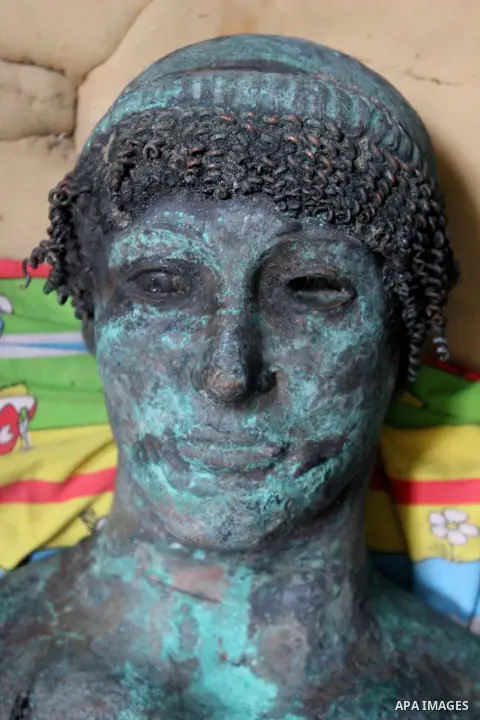 A picture taken on September 19, 2013 shows a 2,500-year-old bronze statue of the Greek god Apollo discovered by Palestinian fishermen last August. Lost for centuries, the rare bronze statue of the Greek God Apollo has m...