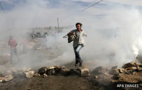 Palestinian protesters clash with Israeli security forces following a demonstration against the expropriation of Palestinian land by Israel in the village of Kfar Qaddum, near the occupied West Bank city of Nablus, on Fe...