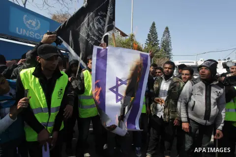 Palestinian supporters of the Popular Resistance Movement, burn a Israeli flag during a protest in solidarity with Muslims in Central African Republic, in front of the headquarter United Nation "UNSCO" in Gaza city, Febr...