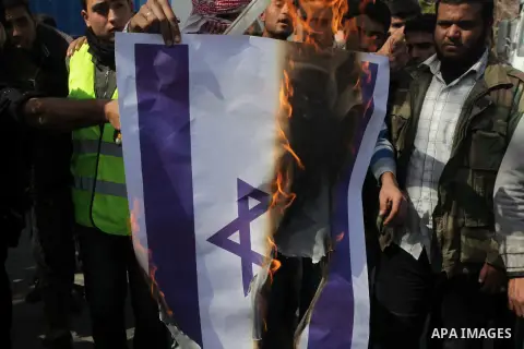 Palestinian supporters of the Popular Resistance Movement, burn a Israeli flag during a protest in solidarity with Muslims in Central African Republic, in front of the headquarter United Nation "UNSCO" in Gaza city, Febr...