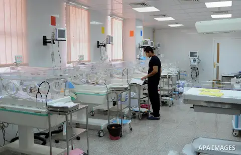 An Egyptian man inspects his newborn baby as he lies in an incubator at a hospital in Cairo on February 23, 2014. Egypt's population has reached 94 million, according to the latest statement released on Feb. 20 from the...