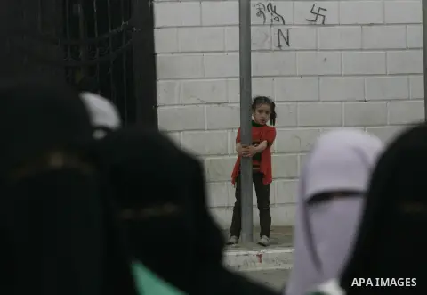Palestinians gather during a protest in front of the Rafah border crossing with Egypt in the southern Gaza Strip on February 24, 2014, to demand that Egypt lift border crossing restrictions. Egypt imposed the restriction...
