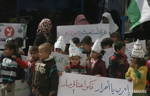 Palestinians hold banners during a protest in front of the Rafah border crossing with Egypt in the southern Gaza Strip on February 24, 2014, to demand that Egypt lift border crossing restrictions. Egypt imposed the restr...