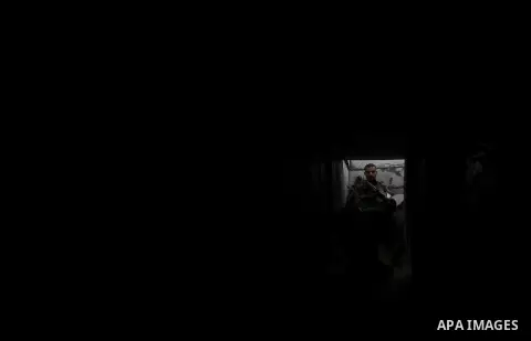 A photo taken on Feb. 17, 2014 shows A Palestinian actor dressed as an Israeli soldier walks in a tunnel during filming in a movie being made in Gaza called, ''Losing Shalit," in Gaza City. "Losing Schalit," currently be...