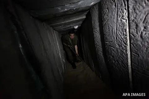 A photo taken on Feb. 17, 2014 shows A Palestinian actor dressed as an Israeli soldier walks in a tunnel during filming in a movie being made in Gaza called, ''Losing Shalit," in Gaza City. "Losing Schalit," currently be...