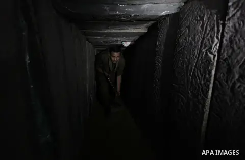 A photo taken on Feb. 17, 2014 shows A Palestinian actor dressed as an Israeli soldier walks in a tunnel during filming in a movie being made in Gaza called, ''Losing Shalit," in Gaza City. "Losing Schalit," currently be...
