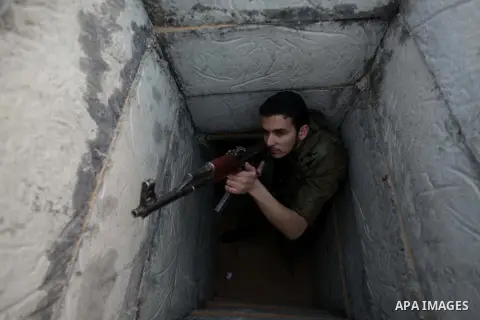 A photo taken on Feb. 17, 2014 shows A Palestinian actor dressed as an Israeli soldier aims his gun from a tunnel during filming in a movie being made in Gaza called, ''Losing Shalit," in Gaza City. "Losing Schalit," cur...