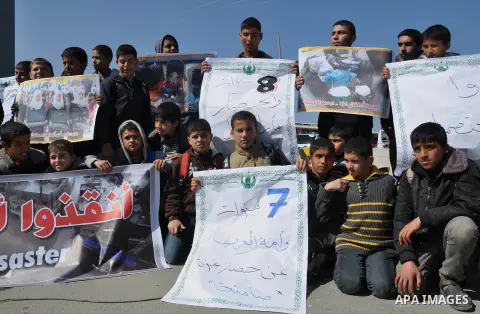 Palestinians hold banners during a protest in front of the Rafah border crossing with Egypt in the southern Gaza Strip on February 24, 2014. to demand that Egypt lift border crossing restrictions. Egypt imposed the restr...