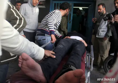 Palestinian medics wheel an injured man at a hospital after he wounded during clashes with Israeli security forces near Nahal Oz border crossing with Israel, east of Gaza City, on February 25, 2014 following a demonstrat...