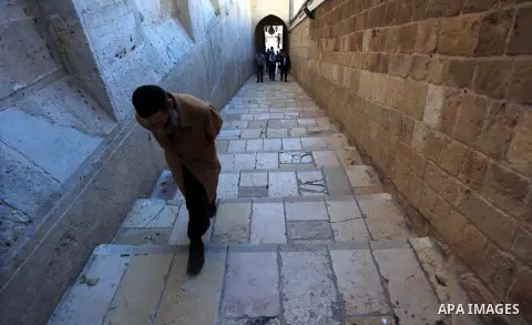 A Palestinian man walks near the Ibrahimi Mosque in the southern West Bank city of Hebron on February 25, 2014. On February 25, 1994, Israeli settler Baruch Goldstein used an assault rifle to gun down worshippers in the...