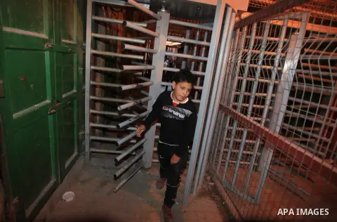 A Palestinian boy passes the gate of the Ibrahimi Mosque in the southern West Bank city of Hebron on February 25, 2014. On February 25, 1994, Israeli settler Baruch Goldstein used an assault rifle to gun down worshippers...