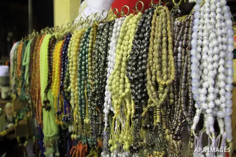 A Egyptian man sells subbah to worshippers after El Ishaa prayers at the Al-Hussein mosque, during celebration day of "Moulid Al-Hussein" the birthday of Prophet Mohammad's grandson Hussein in Cairo, February 25, 2014. P...