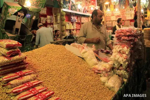 A Egyptian man sells nuts and sweets to worshippers after El Ishaa prayers at the Al-Hussein mosque, during celebration day of "Moulid Al-Hussein" the birthday of Prophet Mohammad's grandson Hussein in Cairo, February 25...