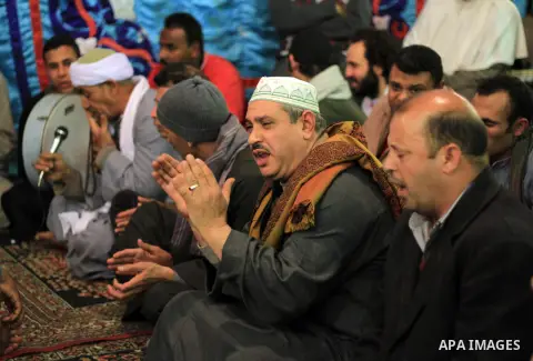 Worshippers attend the El Ishaa prayers at the Al-Hussein mosque, during celebration day of "Moulid Al-Hussein" the birthday of Prophet Mohammad's grandson Hussein in Cairo, February 25, 2014. Photo by Mohammed Bendari