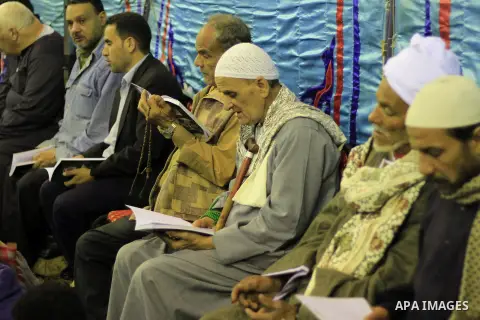 Worshippers read the Koran at the Al-Hussein mosque, during celebration day of "Moulid Al-Hussein" the birthday of Prophet Mohammad's grandson Hussein in Cairo, February 25, 2014. Photo by Mohammed Bendari