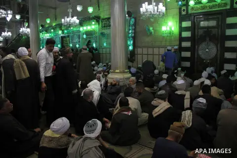 Worshippers read the Koran at the Al-Hussein mosque, during celebration day of "Moulid Al-Hussein" the birthday of Prophet Mohammad's grandson Hussein in Cairo, February 25, 2014. Photo by Mohammed Bendari