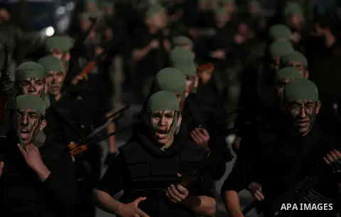 Palestinian students take part in a military march organised by Hamas national security in a street in Rafah town, in the southern Gaza Strip, on February 27, 2014. Thousands of youngsters between the age of six and 16,...