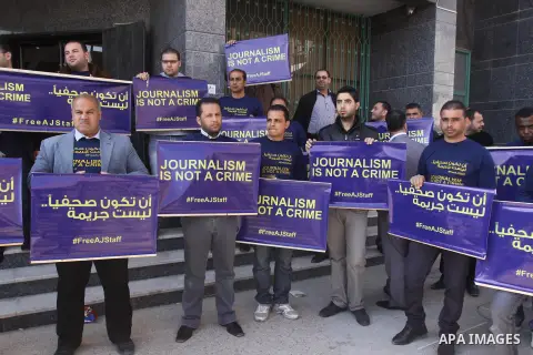 Palestinian journalists hold placards during a protest in support of the Al-Jazeera staff, who have been detained by Egyptian authorities since last year, in Gaza city, Feb. 27, 2014. Qatar-based Al Jazeera TV network ha...