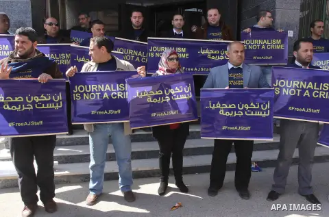 Palestinian journalists hold placards during a protest in support of the Al-Jazeera staff, who have been detained by Egyptian authorities since last year, in Gaza city, Feb. 27, 2014. Qatar-based Al Jazeera TV network ha...