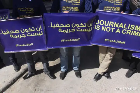 Palestinian journalists hold placards during a protest in support of the Al-Jazeera staff, who have been detained by Egyptian authorities since last year, in Gaza city, Feb. 27, 2014. Qatar-based Al Jazeera TV network ha...