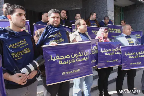 Palestinian journalists hold placards during a protest in support of the Al-Jazeera staff, who have been detained by Egyptian authorities since last year, in Gaza city, Feb. 27, 2014. Qatar-based Al Jazeera TV network ha...