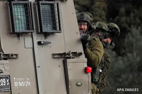 Israeli soldiers take position during clashes with Palestinian demonstrators in the West Bank village of Birzeit, near Ramallah February 27, 2014. The clashes broke out after Israeli forces opened fire and killed a Pales...