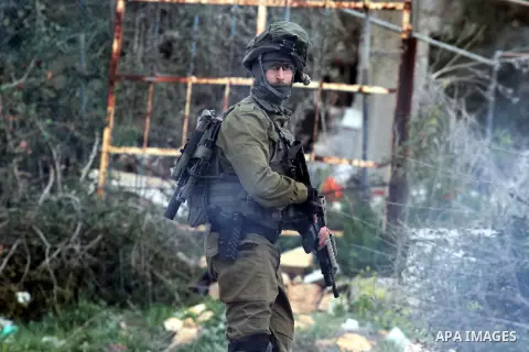 An Israeli soldier takes position during clashes with Palestinian demonstrators in the West Bank village of Birzeit, near Ramallah February 27, 2014. The clashes broke out after Israeli forces opened fire and killed a Pa...