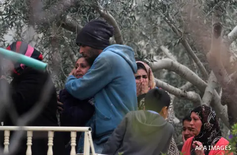 Relatives of Palestinian Moataz Washaha, who died during an Israeli army raid on his home, react as the Israeli soldiers demolish their house in the northern West Bank town of Bir Zeit, near Ramallah on February 27, 2014...