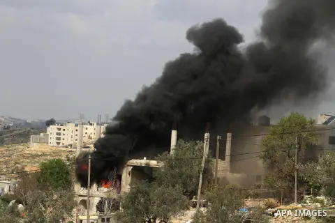 Flames rise from the house of Palestinian Moataz Washaha, who died during an Israeli army raid on his home in the northern West Bank town of Bir Zeit, near Ramallah on February 27, 2014. Israeli forces opened fire and ki...