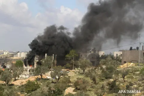 Flames rise from the house of Palestinian Moataz Washaha, who died during an Israeli army raid on his home in the northern West Bank town of Bir Zeit, near Ramallah on February 27, 2014. Israeli forces opened fire and ki...