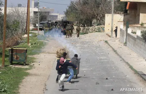 Palestinian youth throw stones at Israeli soldiers during clashes in the West Bank village of Birzeit, near Ramallah February 27, 2014. The clashes broke out after Israeli forces opened fire and killed a Palestinian they...