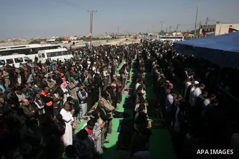 Palestinian Hamas movement supporters take part in Friday prayers outside the Rafah crossing between Gaza Strip and Egypt in protest against the closure of crossing by Egyptian authorities, southern Gaza Strip on Februar...