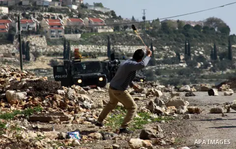 Palestinian protesters clash with Israeli security forces following a demonstration against the expropriation of Palestinian land by Israel in the village of Kfar Qaddum, near the occupied West Bank city of Nablus, on Fe...