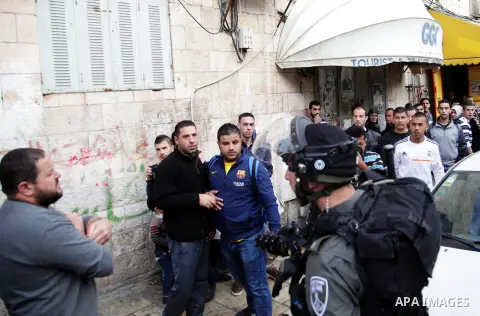 Israeli policemen arrest a Palestinian during clashes in East Jerusalem neighborhood Ras al-Amud, on March 01, 2014. Photo by Saeed Qaq