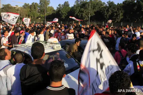 Egyptians stand outside the sports flowers club's headquarters before al-zamalek match against kaboscorb during the African Super Cup soccer in Cairo, capital of Egypt, on March 1, 2014. Photo by Mohammed Bendari