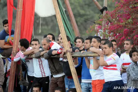Egyptians stand outside the sports flowers club's headquarters before al-zamalek match against kaboscorb during the African Super Cup soccer in Cairo, capital of Egypt, on March 1, 2014. Photo by Mohammed Bendari