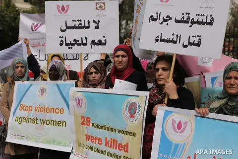 Palestinian women hold placards and shout slogans during a rally to protest against the rising incidents of violence against women in Gaza City March 03, 2014. Twenty-six women were slain by relatives in the West Bank an...
