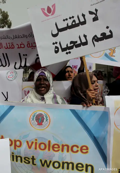 Palestinian women hold placards and shout slogans during a rally to protest against the rising incidents of violence against women in Gaza City March 03, 2014. Twenty-six women were slain by relatives in the West Bank an...