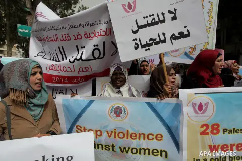 Palestinian women hold placards and shout slogans during a rally to protest against the rising incidents of violence against women in Gaza City March 03, 2014. Twenty-six women were slain by relatives in the West Bank an...