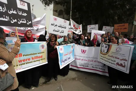 Palestinian women hold placards and shout slogans during a rally to protest against the rising incidents of violence against women in Gaza City March 03, 2014. Twenty-six women were slain by relatives in the West Bank an...