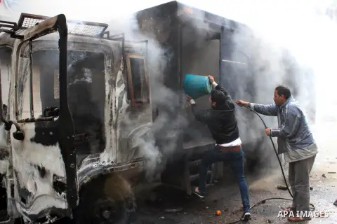 Egyptians try to extinguish a police vehicle set on fire during clashes between supporters of ousted Egyptian President Mohamed Mursi and security forces at Faisal street in Cairo March 07, 2014. Photo by Mohammed Bendar...