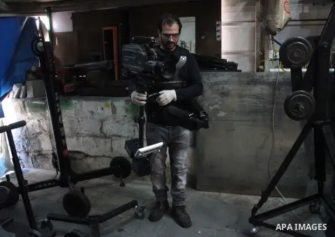 Imad al-Kronz, a Palestinian man works on an camera crane, at his workshop in al-Arrub refugee camp, near the West Bank City of Hebron, March 07, 2014. al-Kronz, studies the journalism and he have a hobby to make all of...