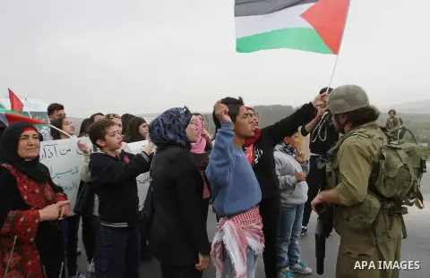 Supporters of the 'Union Of Palestinian Women Committees' (UPWC) have an argument with Israeli solders during a rally marking the International Woman's Day at Hawara checkpoint near the West Bank city of Nablus, on March...